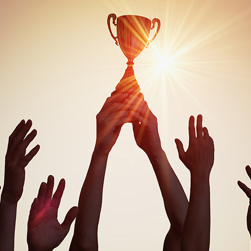 People holding up a trophy