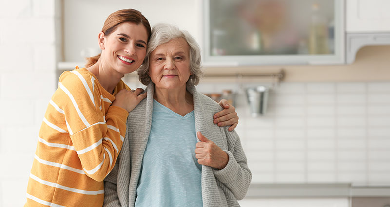Caregiver Connection Elderly woman with female caregiver in kitchen