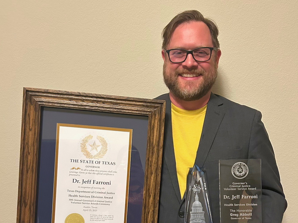 Dr. Farroni holding award.