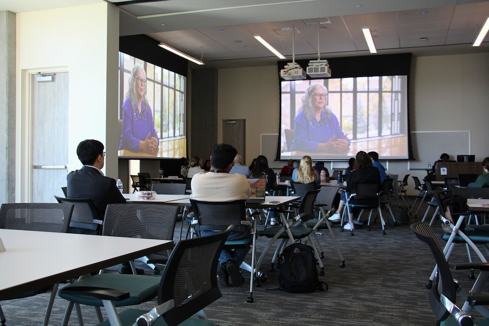 Event attendees watch a film