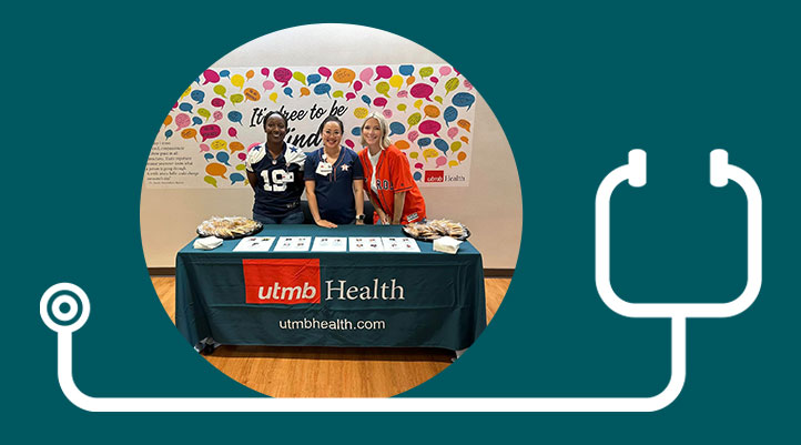 Three UTMB APPs stand behind a table with two trays of cookies and several stacks of paper.
